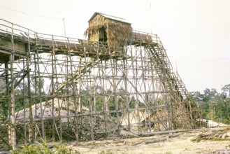 Open Cast gravel-pumping tin mine Malaya, Malaysia, south east Asia 1964 - pumping raises the