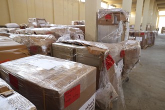 Relief workers unload boxes of medical aid provided by Qatar at Damascus International Airport,