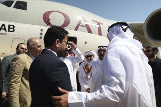 Syrian Health Minister Musab al-Omar welcomes a Qatari aircraft loaded with medical and