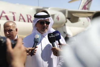 Officials from the Qatari and Syrian Red Crescents receive a Qatari airlift of aid to help the