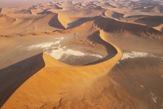 Sand dunes and dry pans in the Namib Desert. In the evening. Aerial view. Namib-Naukluft Park,