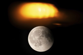 After a total lunar eclipse, the moon appears shortly after its rise in the evening sky as a