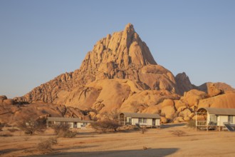 The isolated Spitzkoppe mountain (1728 m) provides a dramatic backdrop for the chalets of the