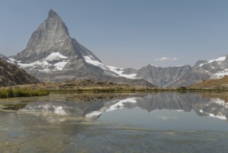 A stunning view of the Matterhorn mountain towering in the background, reflecting perfectly in a