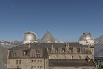This breathtaking view shows the iconic Matterhorn mountain rising behind a historic observatory