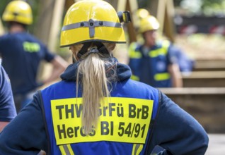 Construction of a temporary bridge over a slipped road crossing a stream, by the bridge