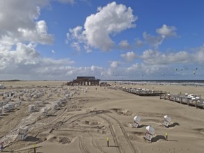 North Sea beach with sand drifts, car park, blue sky, white clouds, summer, sun, beach chairs, on