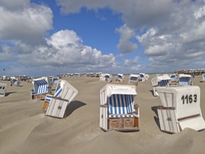 Sand drifts on the North Sea beach, blue sky, white clouds, summer, sun, sand, beach chairs, on the