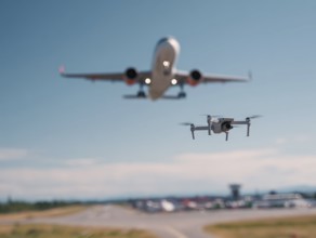 Ein Quadrocopter, Drohne, droht mit einem startenden Verkehrsflugzeug zu kollidieren, während ein