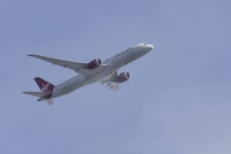 Boeing 787 Dreamliner jet passenger aircraft of Virgin Atlantic airlines in flight in a blue sky,