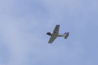 Alpi Pioneer 300 light aircraft flying in a blue sky, England, United Kingdom