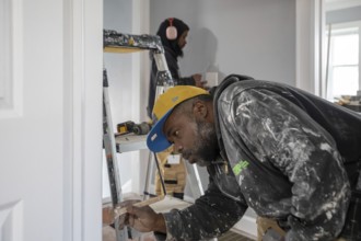 Detroit, Michigan - Workers remodel a house in the Morningside neighborhood that had been vacant