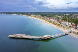 Aerial view over Seebrücke, pier and sandy beach at seaside resort Haffkrug along the Baltic Sea,