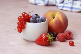 Various fruits in peel, redcurrant, peach, strawberry, blueberry, blackberry, raspberry