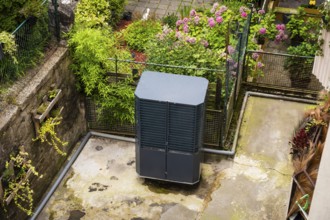 Heat pump in a backyard in Wuppertal, Germany, digitally reworked