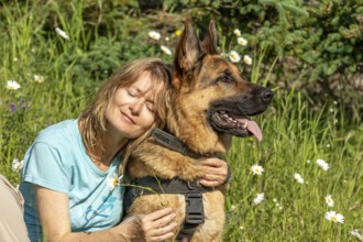Woman hugging her German Shepherd, Gaspesie Region, Province of Quebec, Canada, North America