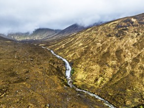 Eas a' Bhradain Waterfall from drone, Red Cuillin mountains, Loch Ainort, Isle of Skye, Scotland,