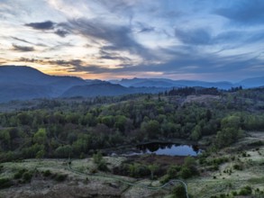 Sunset over Mountains and Coniston Water from drone, Lake District National Park, Cumbria, England,