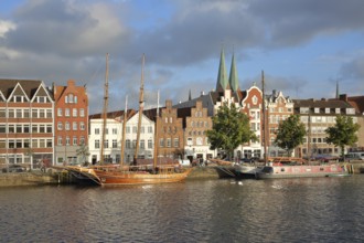 Ships on the banks of the Stadttrave, houses, cityscape, sailing ship, harbour, steeples of St.