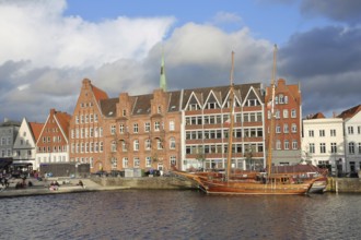 Sailing ship on the banks of the Stadttrave, houses, cityscape, quay, harbour, light atmosphere,