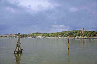 Trave with monument to sailor Fiete, wood carving, Dückdalbe, dolphin, old lighthouse, shore,