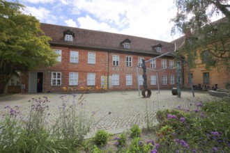 Cultural Forum and Schleswig-Holstein House, brick building, sculpture, inscription, Schelfstadt,