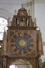 Rood screen with Gothic clock built in 1477 with decorations and figures, interior view, church