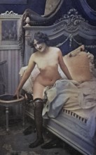 Female nude from around 1899, erotic postcard, Playgirl, A woman sits naked on a vintage bed in a