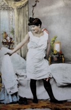 Female nude from around 1899, erotic postcard, playgirl, woman in nightgown looking at herself in