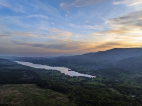 Sunset over Mountains and Coniston Water from drone, Lake District National Park, Cumbria, England,