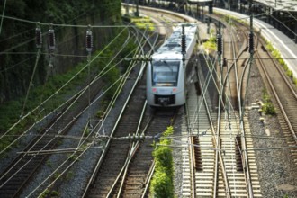 Overhead lines and tracks with train at the railway station in Wuppertal, Germany