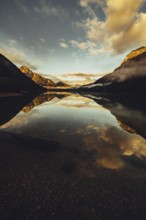 Sunrise with reflections in Lake Heiterwanger See in Tyrol in the Alps in Austria