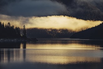 Sunrise with reflections in Lake Heiterwanger See in Tyrol in the Alps in Austria