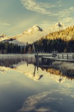 Lake Staz near Sankt Moritz in the Engadin in Switzerland. Morning atmosphere with fog in autumn.