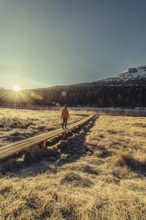 Young woman at Lake Staz near Sankt Moritz in the Engadine in Switzerland. Morning atmosphere with
