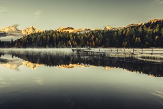 Lake Staz near Sankt Moritz in the Engadin in Switzerland. Morning atmosphere with fog in autumn.