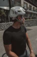Young man riding a racing bike on Lake Garda. Sunny weather and dolce vita