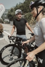Woman and man cycling on Lake Garda in Italy. Sunny weather and dolce vita