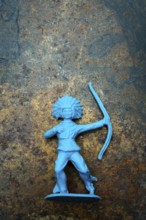 A vibrant blue plastic toy archer stands confidently, showcasing its detailed representation of an