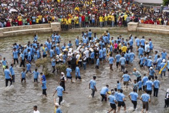 People from the Pnar community perform rituals as they using a tree to celebrate an event organised