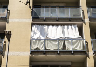 A balcony protected from the heat with white curtains in Bratislava, Slovakia