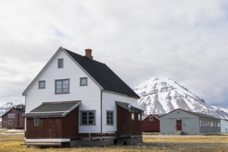 Wooden house in front of a mountain peak, Ny-Alesund, Spitsbergen, Svalbard