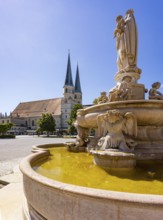 Marienbrunnen fountain on Kapellplatz with St.Philippus and Jakobus collegiate parish church, place