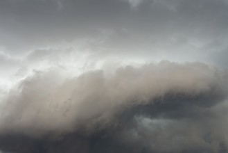 Below dark discoloured storm clouds Cloud roll above grey clouds Rain clouds heralding