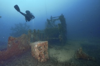 A diver examines an old shipwreck on the seabed. Dive site wreck Ville de Grasse, Giens peninsula,