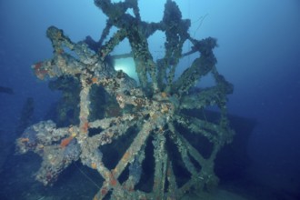 Dilapidated paddle wheel of a shipwreck in blue surroundings. Dive site wreck Ville de Grasse,