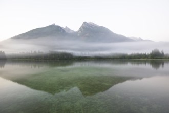 Magical sunrise with fog at Hintersee near Ramsau in Berchtesgadener Land