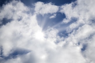 Symbolic image, global warming, heat, the sun shines through partly overcast clouds and illuminates