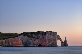 Rock arch Falaise or Porte d'Aval and rock needle Aiguille, illuminated, illuminated, Étretat, sea,