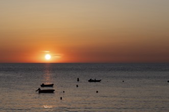 Boats in front of sunset at the sea, North Sea, English Channel, Étretat, evening mood,